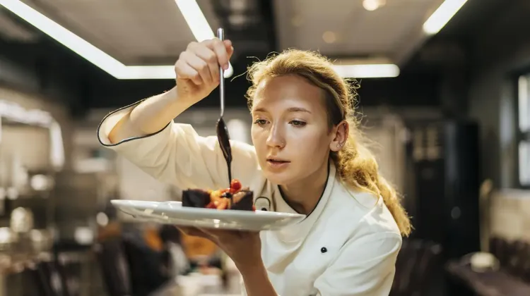 female-chef-carefully-pouring-sauce-dish.jpg